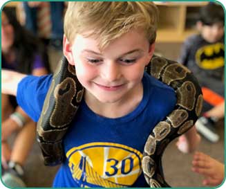 Kidz Korner Summer Camp child with a snake